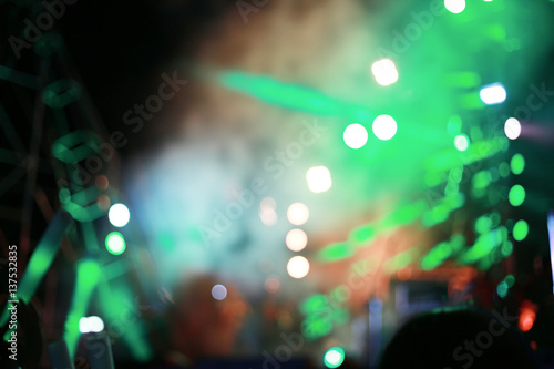 Blurred background concert : Bokeh lighting in concert with audience, Music showbiz concept, music performance concert with bokeh spotlight. entertainment concert lighting on stage, blur disco party