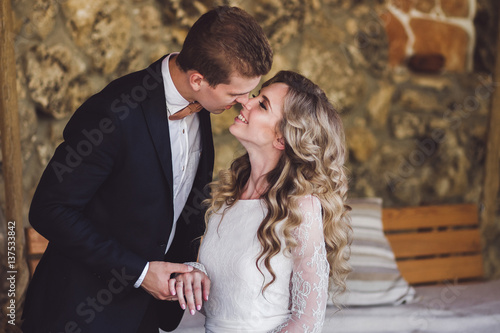Stylish wedding couple kissing © Oleg Breslavtsev