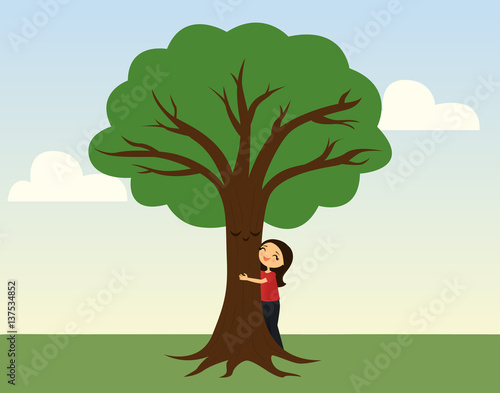 Smiling girl hugging a tree