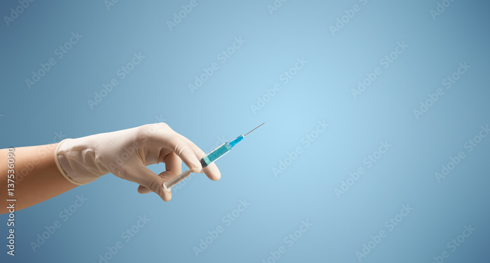 Female doctor holding syringe Female doctor holding syringe