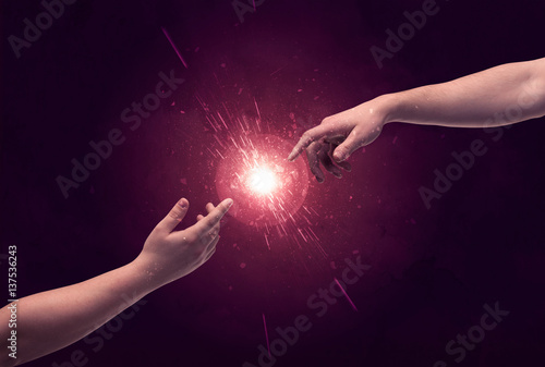 Touching hands light up sparkle in space
