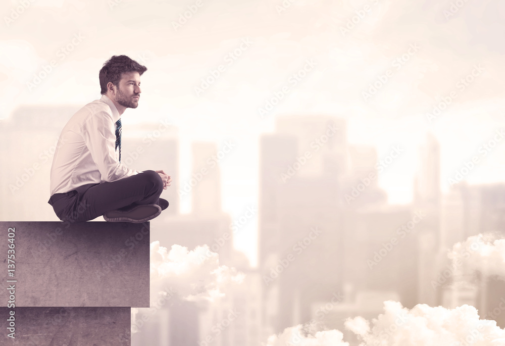 Peaceful sales guy sitting on roof top Peaceful sales guy sitting on roof top