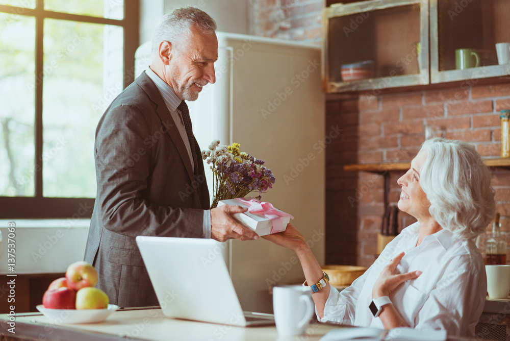 Pleasant loving couple resting in the kitchen Pleasant loving couple resting in the kitchen