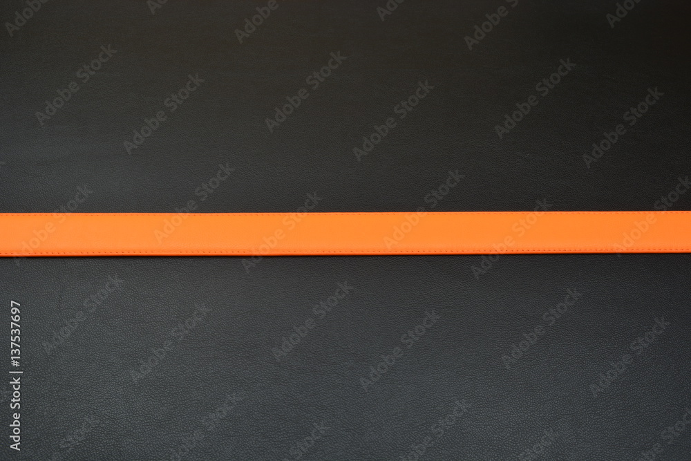Fototapeta premium Orange belt on black background