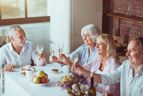 Positive aged couples enjoying festive dinner © zinkevych