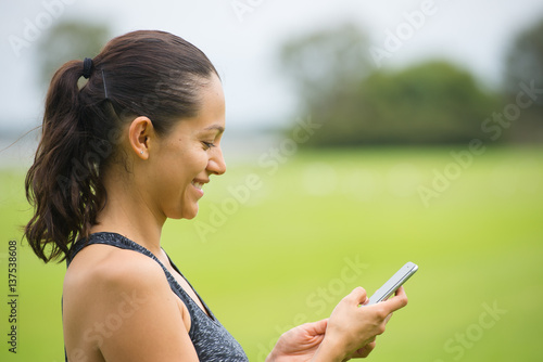 Young smiling woman on smart phone outdoor