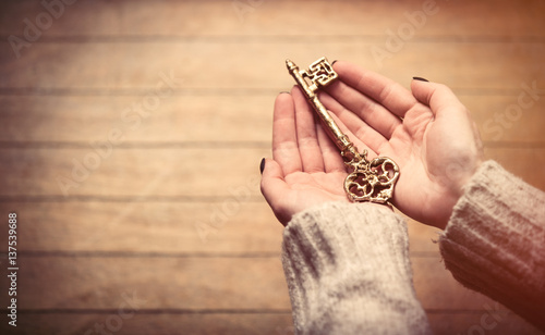 hands holding key