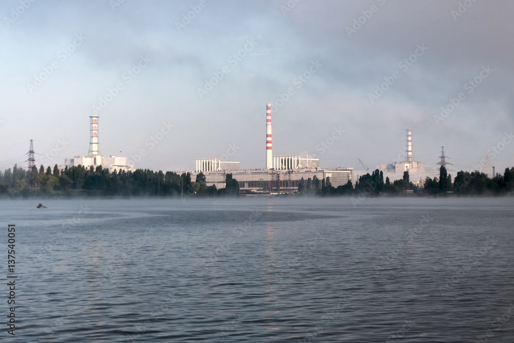 Kursk Nuclear Power Plant reflected in a calm water surface.