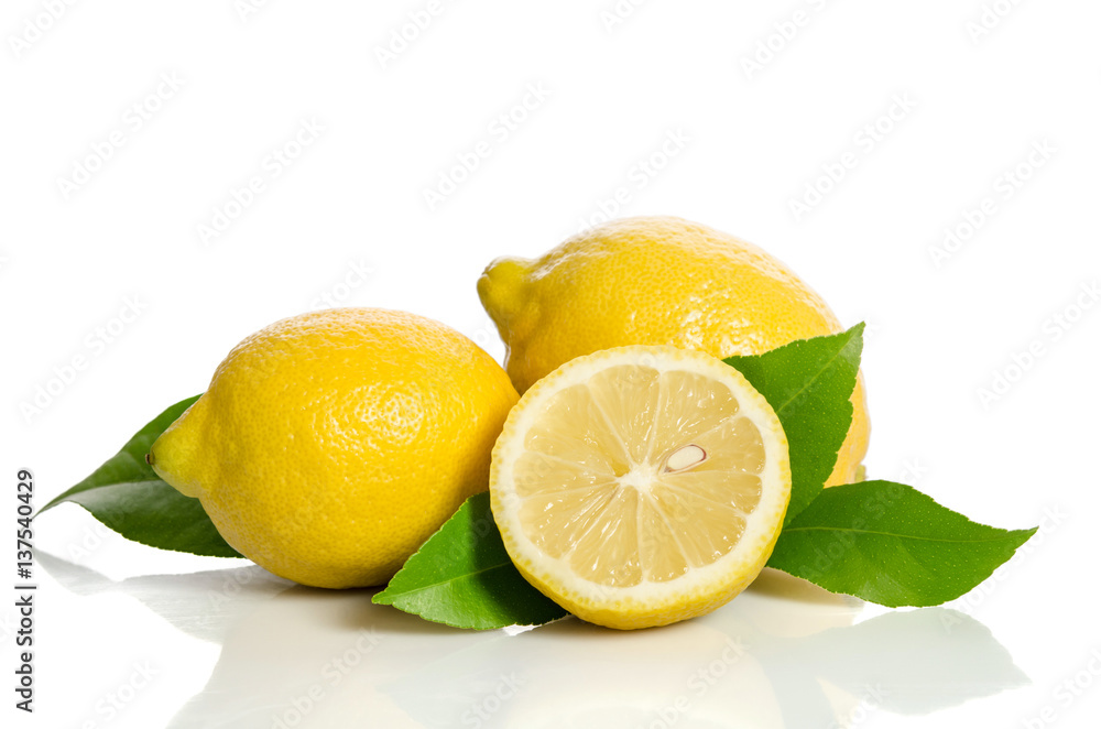 Two lemons and half with leaves isolated on white background Two lemons and half with leaves isolated on white background