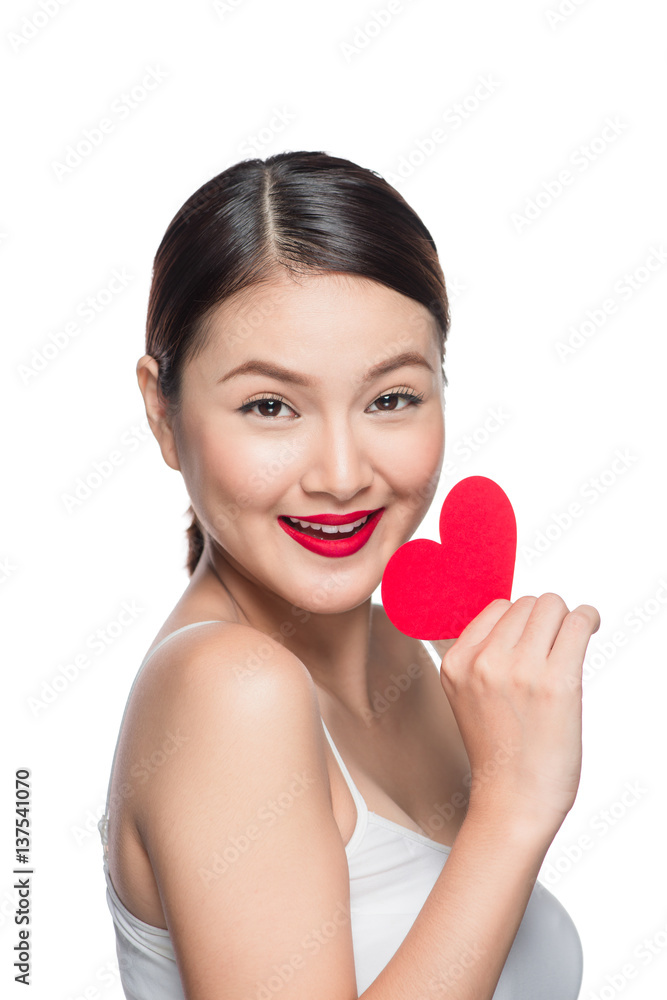 Attractive young woman with red heart. Valentine's day art portrait. Perfect make up