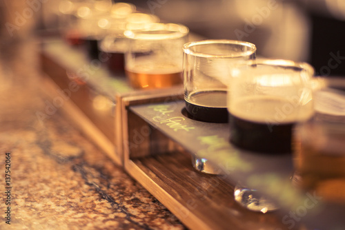 close up of beer flights lined up on bar