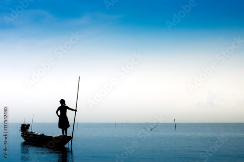 Blue sky and Silhouettes of fisherman, Thailand.