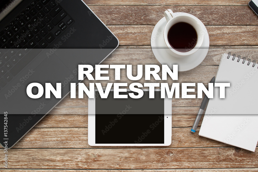 Tablet on desktop with return on investment text. Tablet on desktop with return on investment text.