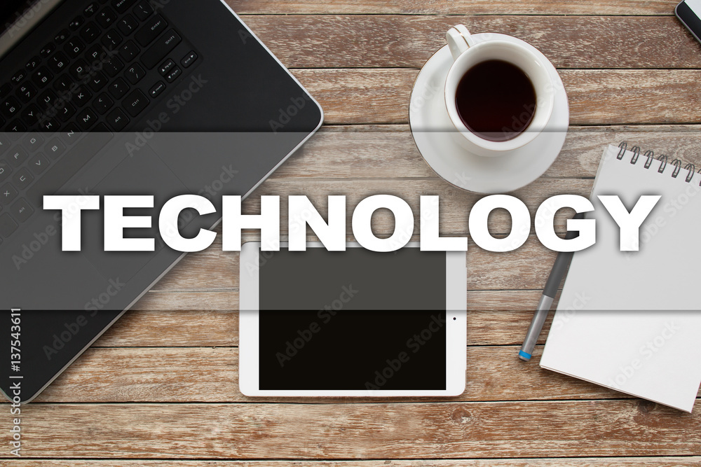 Tablet on desktop with technology text. Tablet on desktop with technology text.