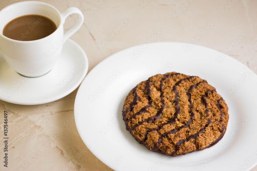 Oatmeal cookies with chocolate on a white plate. Tasty dessert. Oatmeal cookies with chocolate on a white plate. Tasty dessert.