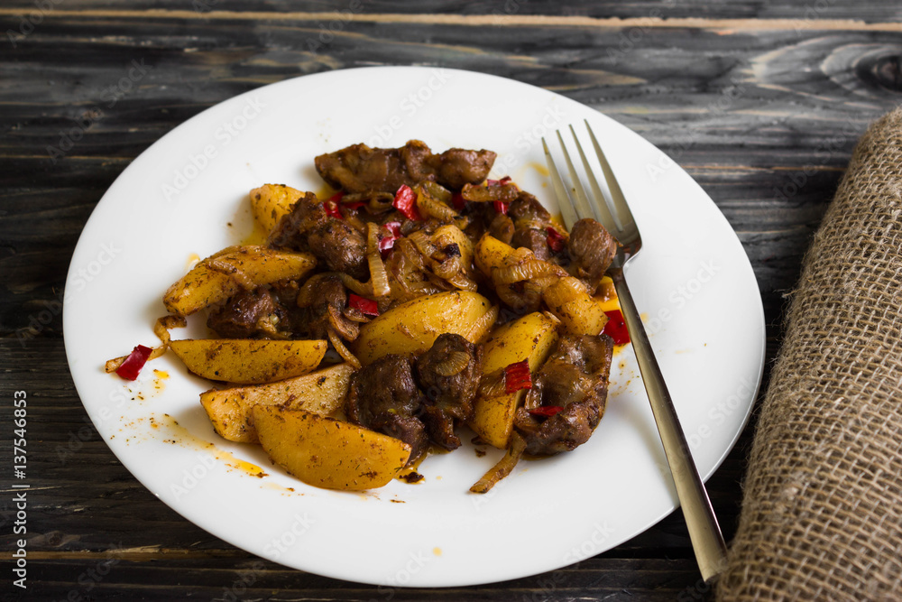 Fried chicken gizzards on a wooden background in rustic style