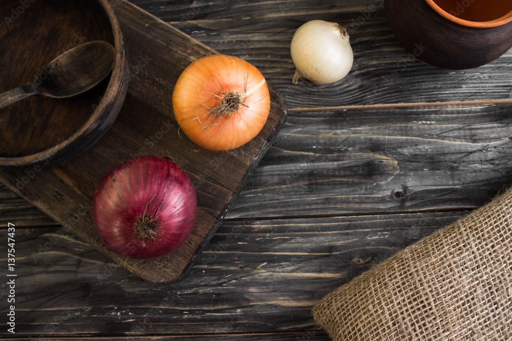 Onion on a wooden background in rustic style