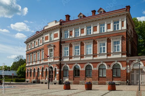 Red brick classic building from 19th century. Bright sunny day in European city.