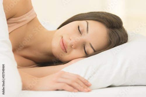 The young woman sleeping on the bed