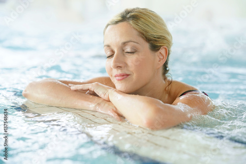 Beautiful blond woman relaxing in thalassotherapy thermal water