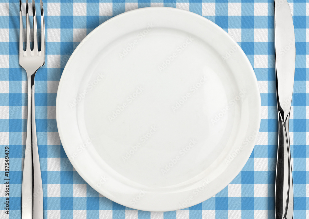 Table setting, empty plate and silverware on towel, top view Table setting, empty plate and silverware on towel, top view