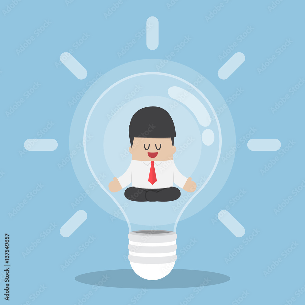 Businessman doing meditation inside light bulb