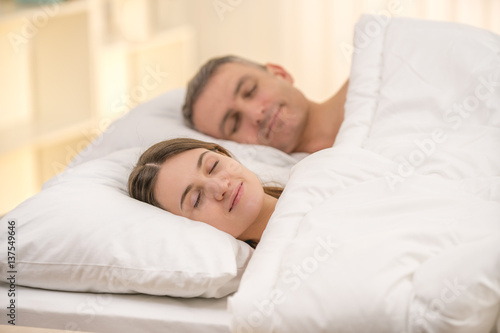 The beautiful couple sleeping on the bed