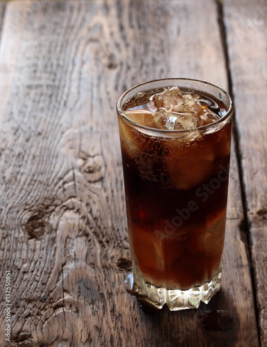Fresh cold drink with ice on a wooden background