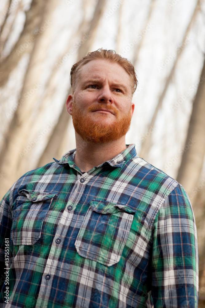 Portrait of red haired man with long beard in the forest Portrait of red haired man with long beard in the forest