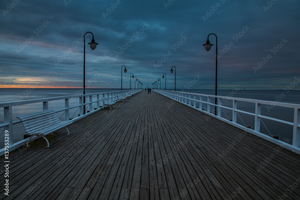 Wooden pier in Gdynia Orlowo in the morning with colors of sunrise. Poland. Europe.