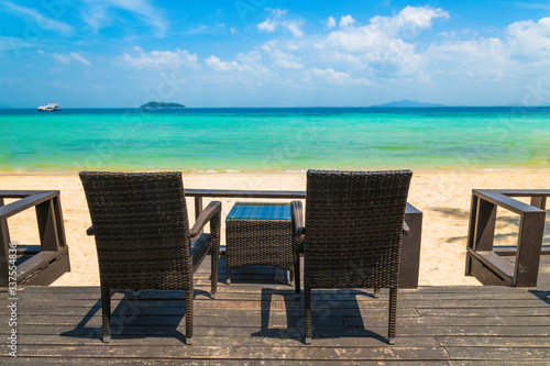 Beach chairs on the white sand beach at summer terrace restaurant