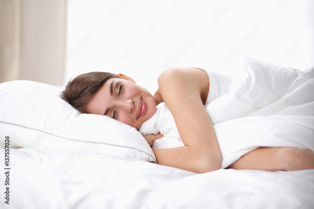 Beautiful girl sleeps in the bedroom, lying on bed Beautiful girl sleeps in the bedroom, lying on bed