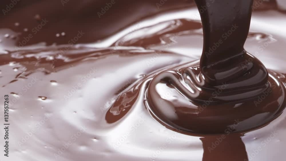 Slow motion of pouring melted premium dark chocolate, 180fps prores footage Slow motion of pouring melted premium dark chocolate, 180fps prores footage