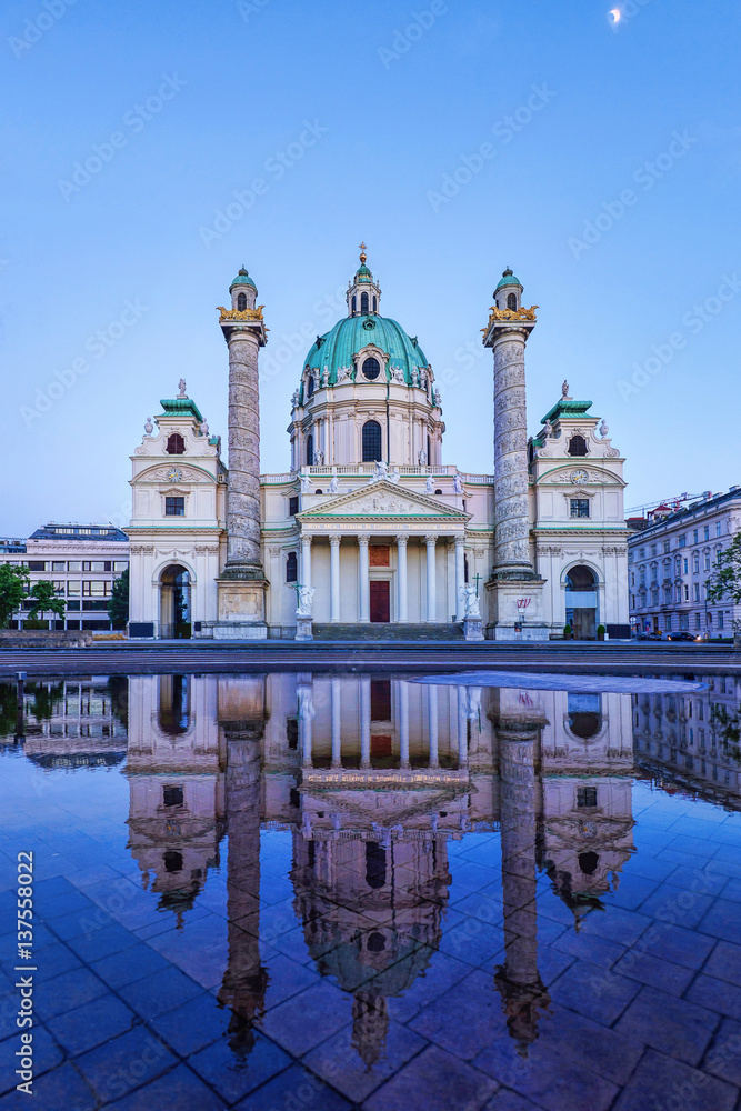 Karlskirche in Vienna Austria at sunset with reflection and shining moon in the purple sky, St Charles's church