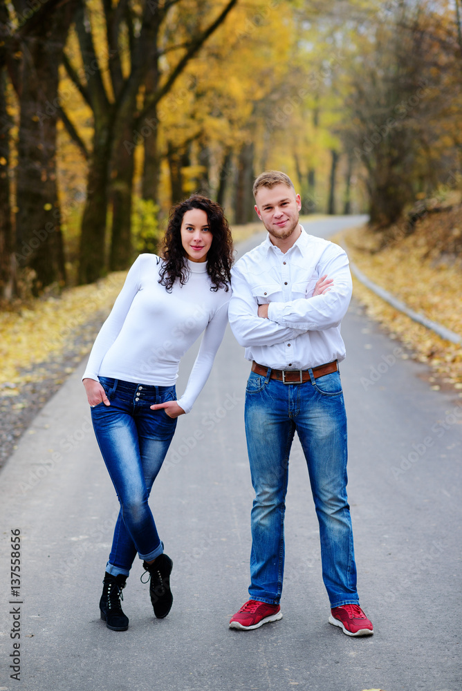 Lovers walking hand in hand in autumn park Lovers walking hand in hand in autumn park