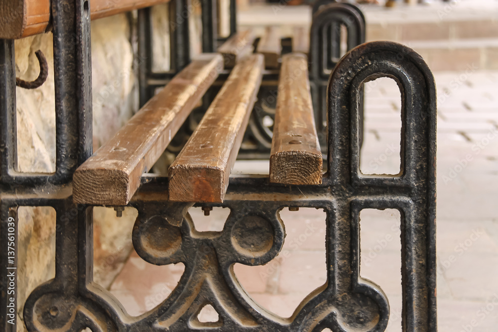 Old style bench with metal frame and wooden seat Old style bench with metal frame and wooden seat