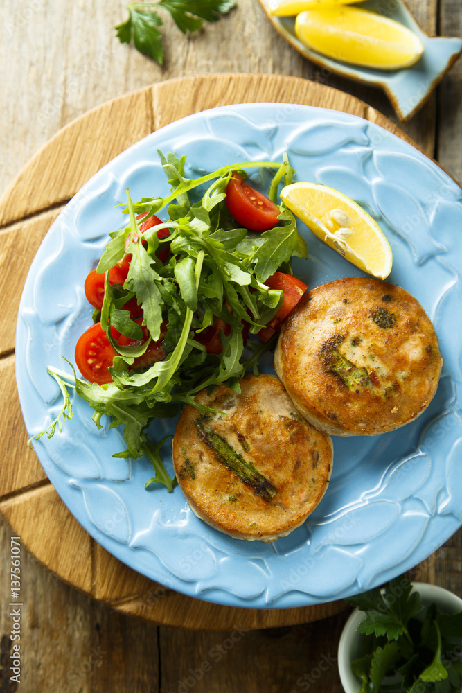 Salmon cakes with vegetables and arugula salad Salmon cakes with vegetables and arugula salad