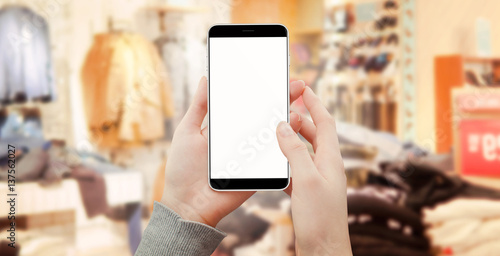 Women holding smartphone in boutique shopping online