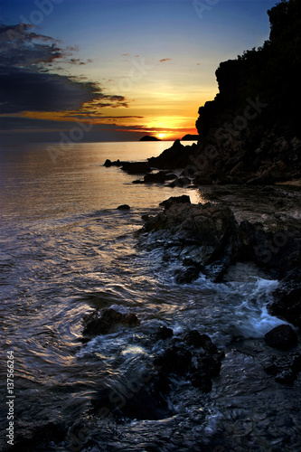 Rocky shore of the ocean and the sunset