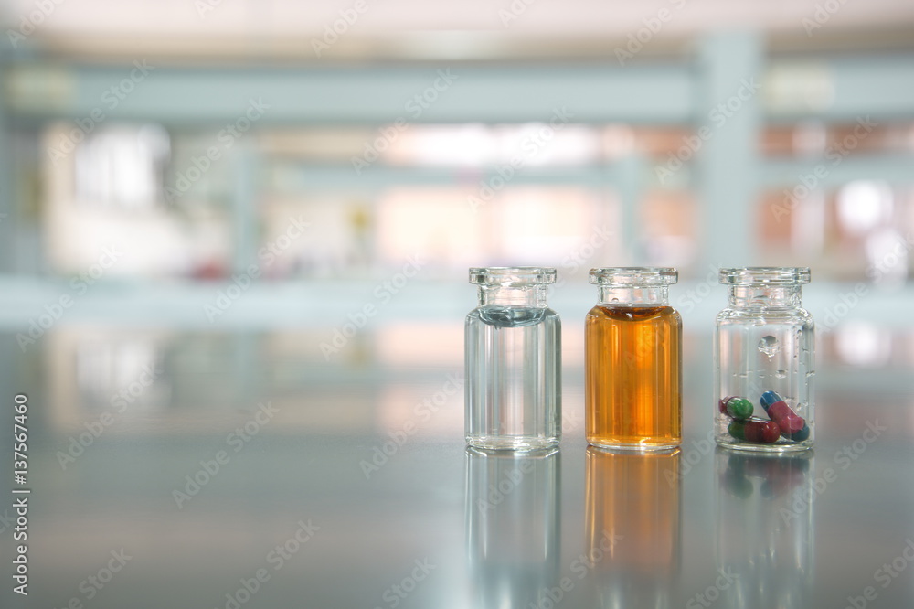 three vials with capsule pill orange and water solution in science laboratory three vials with capsule pill orange and water solution in science laboratory