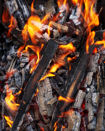 Bright flames. BBQ grill. Hot coal. Burned wood 