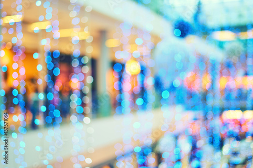 Bright blue Christmas garlands for decorations in the lobby of the mall. Blurred bokeh basic background for design
