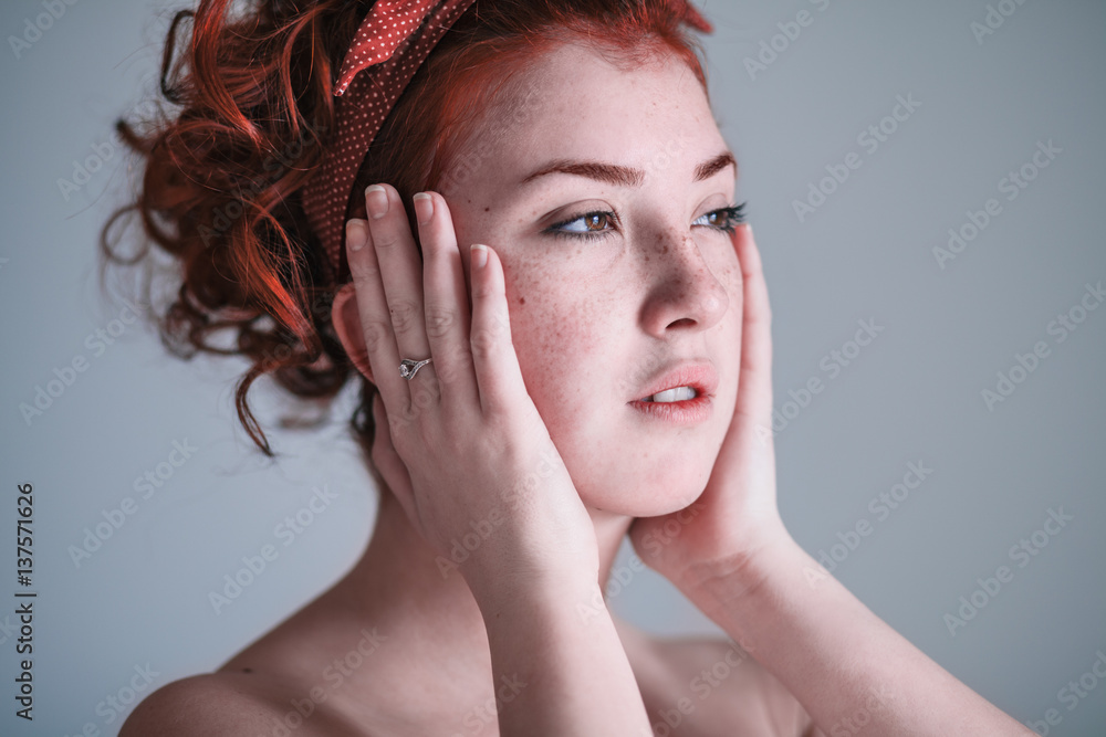 Fototapeta premium Young woman looking worried by the window