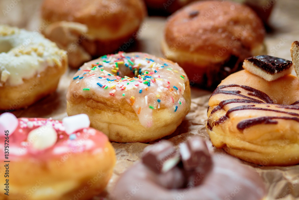 Delicious colorful donuts on baking paper