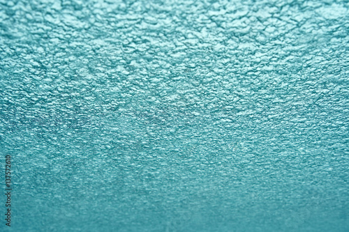 Bright background of falling snow on the windshield of the car. View from inside the car. Basic background for design