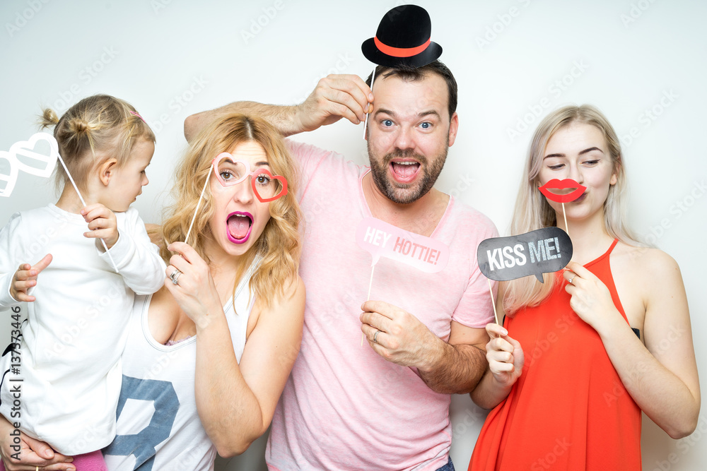 happy smile family dad mom daughter baby sitter strike a pose party photo booth props laugh