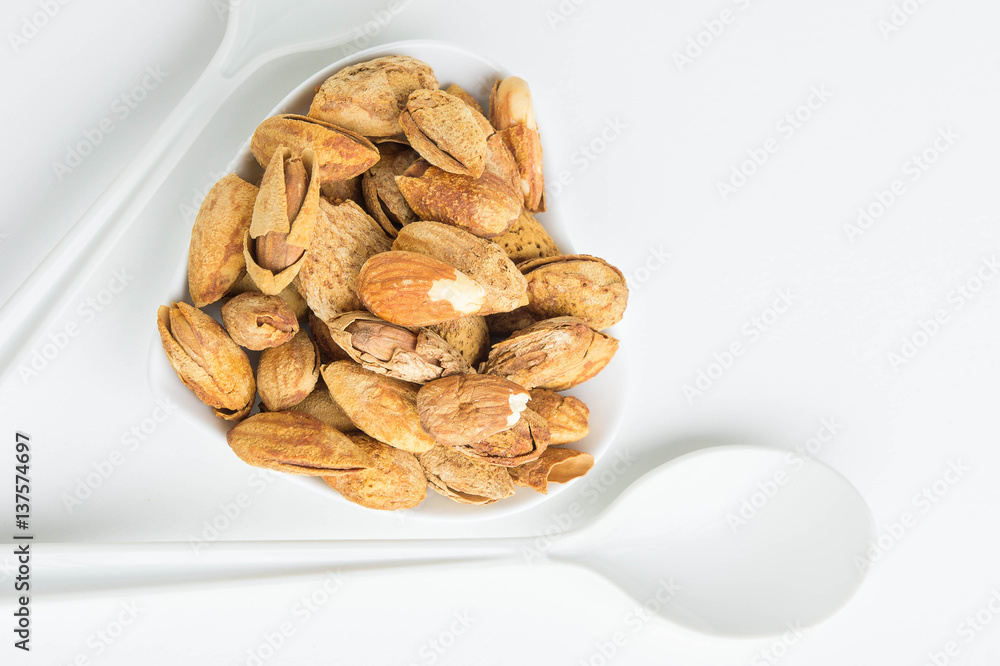 Almond nuts to stay healthy for the body. almond on white background Almond nuts to stay healthy for the body. almond on white background