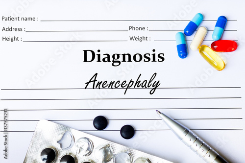 Anencephaly - Diagnosis written on a piece of white paper with medication and Pills photo