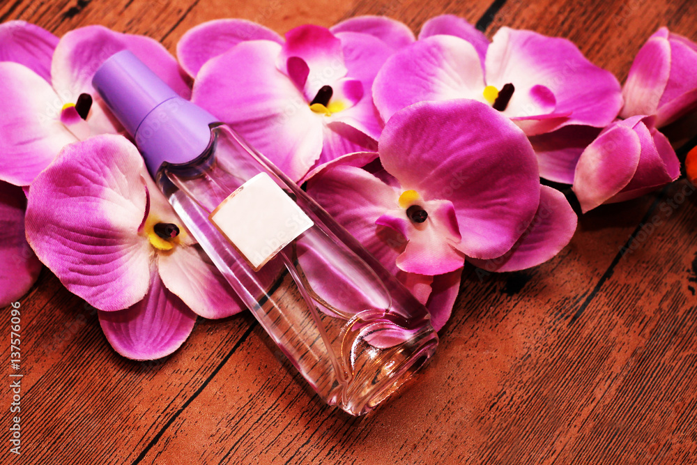 Beautiful Orchid and perfume on a wooden background, gift Beautiful Orchid and perfume on a wooden background, gift