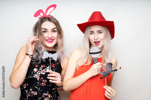 happy ladies girls female with fancy dress photo booth props smile party white isolated background